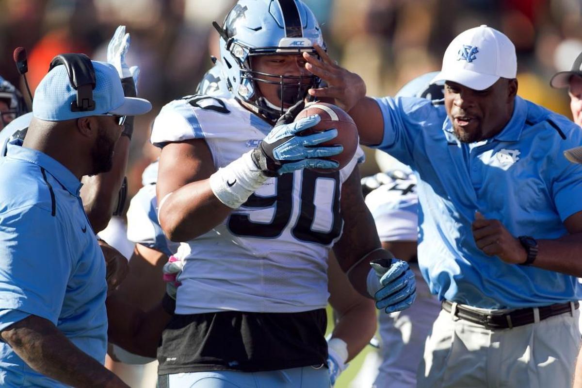 UNC’s Nazair Jones is greeted by coaches after Jones’ interception of Virginia quarterback Greyson Lambert in 2014. Jones was the 102nd pick in the 2017 NFL draft, going to the Seattle Seahawks.