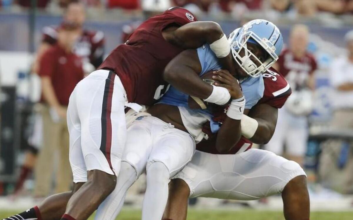 
UNC quarterback Marquise Williams (12) is sacked by USC defensive end Darius English (5) and defensive tackle Kelsey Griffin (94) during the Belk College Kickoff at Bank of America Stadium in Charlotte,.
