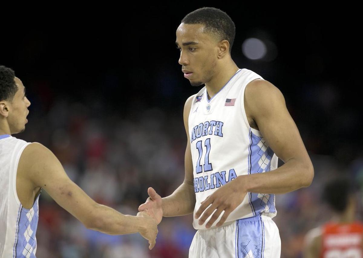 North Carolina's Marcus Paige (5) and North Carolina's Brice Johnson (11) congratulate each other as they come off the court late in the second half of UNC's 83-66 victory over Syracuse in the semifinals of the 2016 NCAA Division I Men's Basketball Championship at NRG Stadium in Houston, Texas, on April 2, 2016.