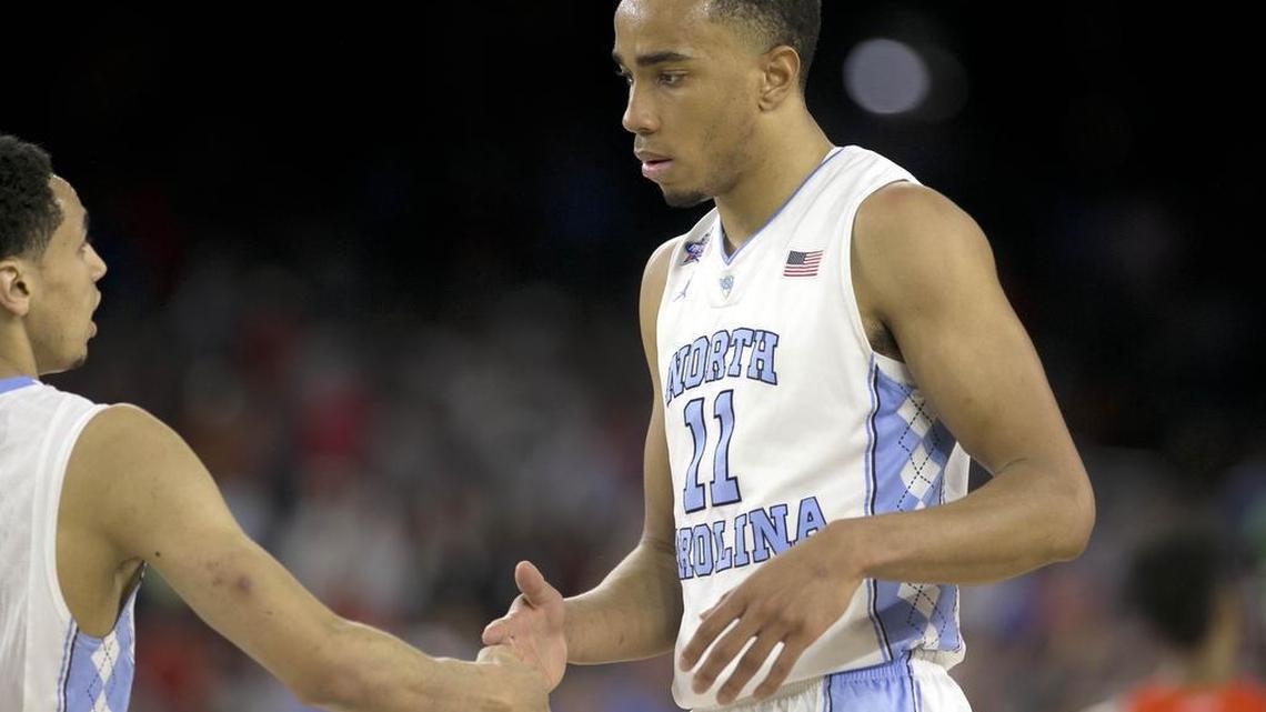 North Carolina's Marcus Paige (5) and North Carolina's Brice Johnson (11) congratulate each other as they come off the court late in the second half of UNC's 83-66 victory over Syracuse in the semifinals of the 2016 NCAA Division I Men's Basketball Championship at NRG Stadium in Houston, Texas, on April 2, 2016.