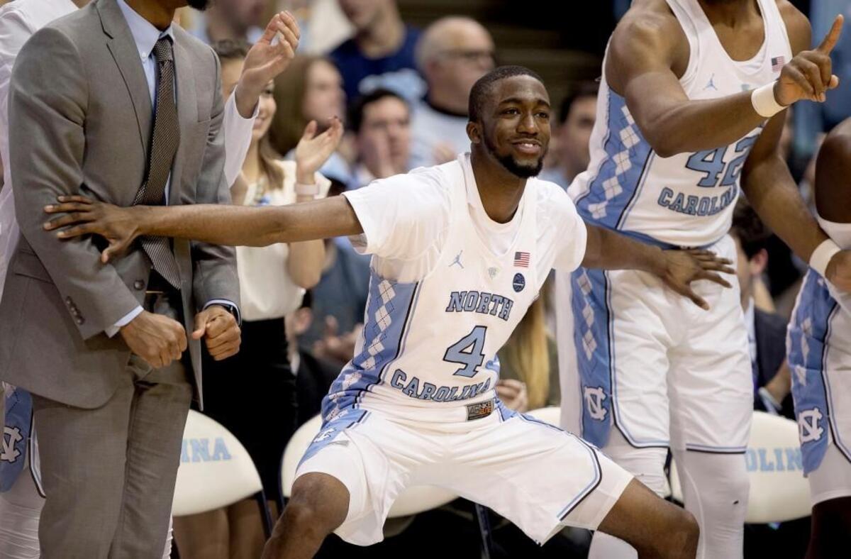North Carolina's Brandon Robinson (4) reacts after a dunk by teammate Garrison Brooks (15) during the second half.