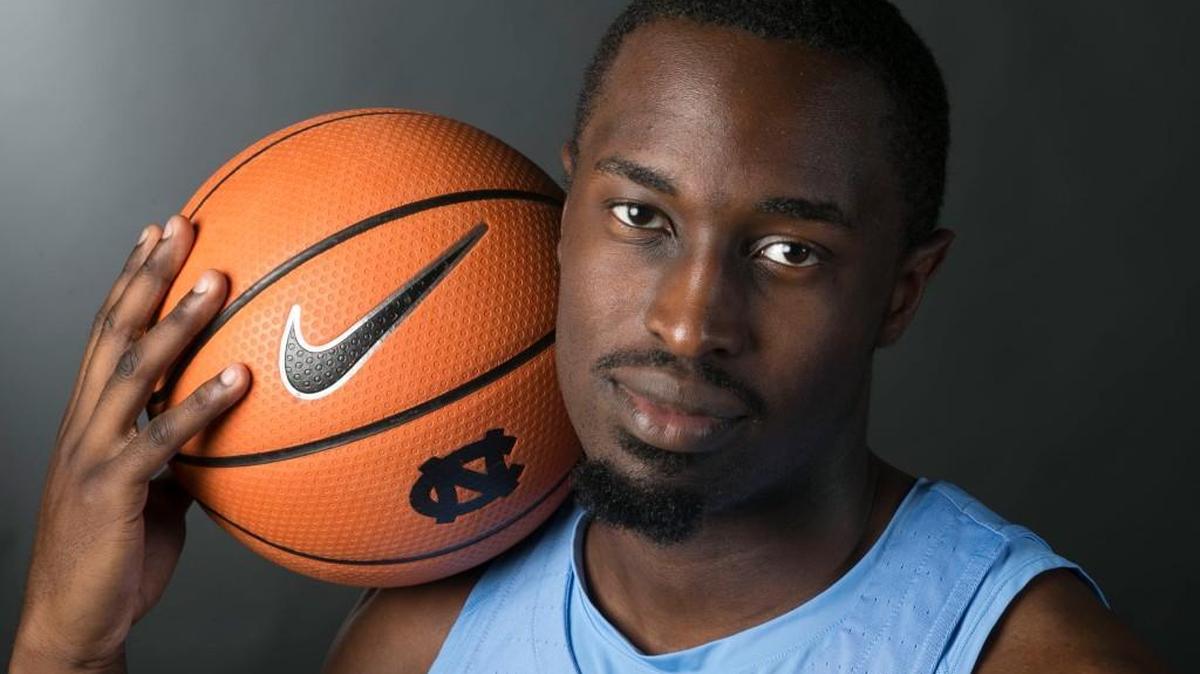 North Carolinas Theo Pinson (1) poses for a portrait during the Tar Heels media day holding a basketball featuring the Nike swoosh logo.
