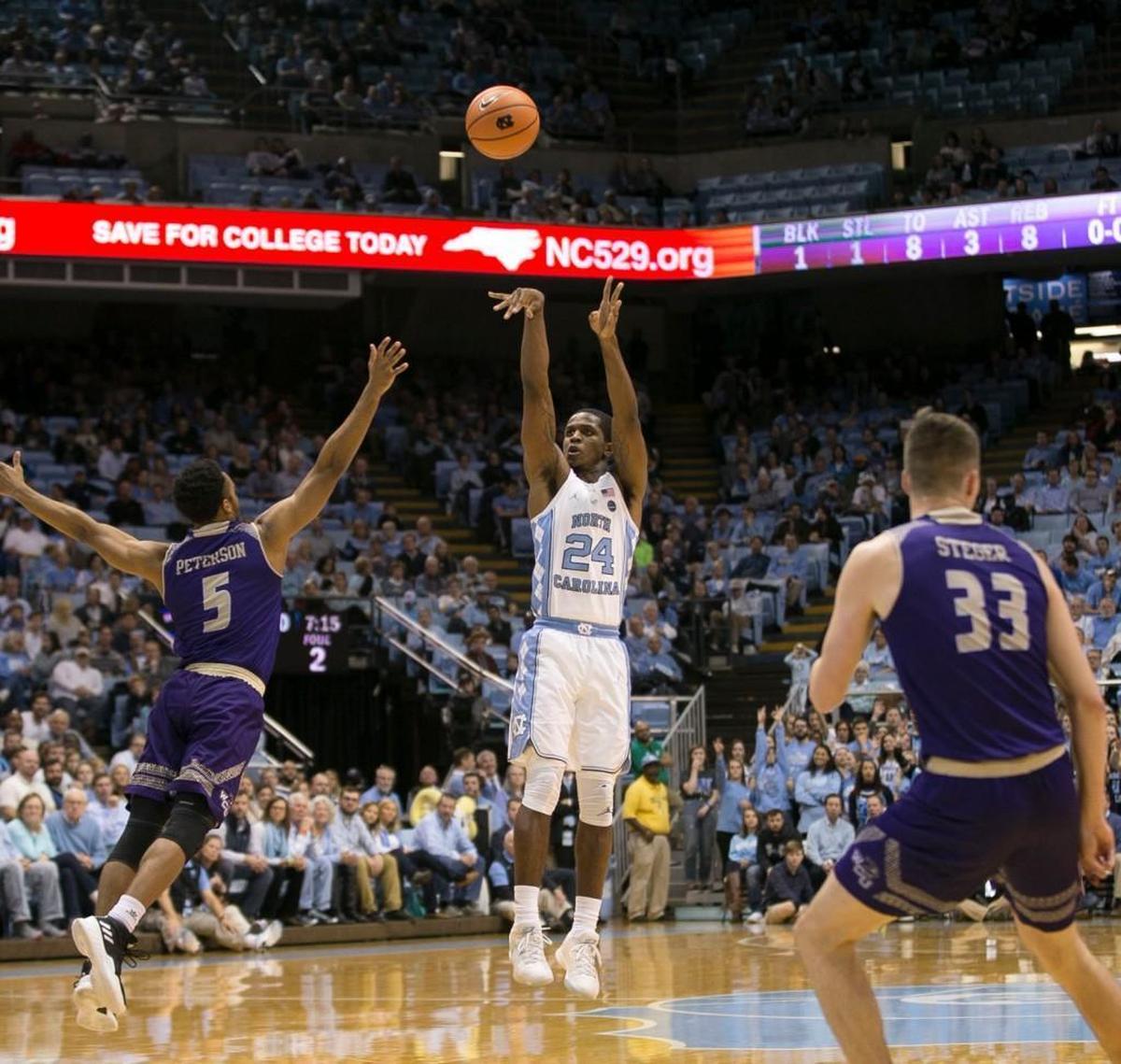 North Carolina’s Kenny Williams (24) launches a three-point shot over Western Carolina’s Devin Peterson (5) during the first half on Wednesday, December 6, 2017 at the Smith Center in Chapel Hill, N.C.