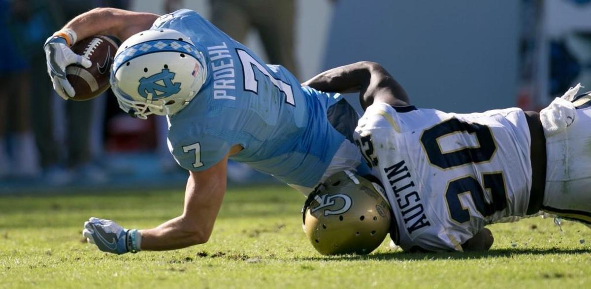 North Carolina’s Austin Proehl, right, picks up eight yards on a pass completion from quarterback Mitch Trubisky before being stopped by Georgia Tech’s Lawrence Austin in November.