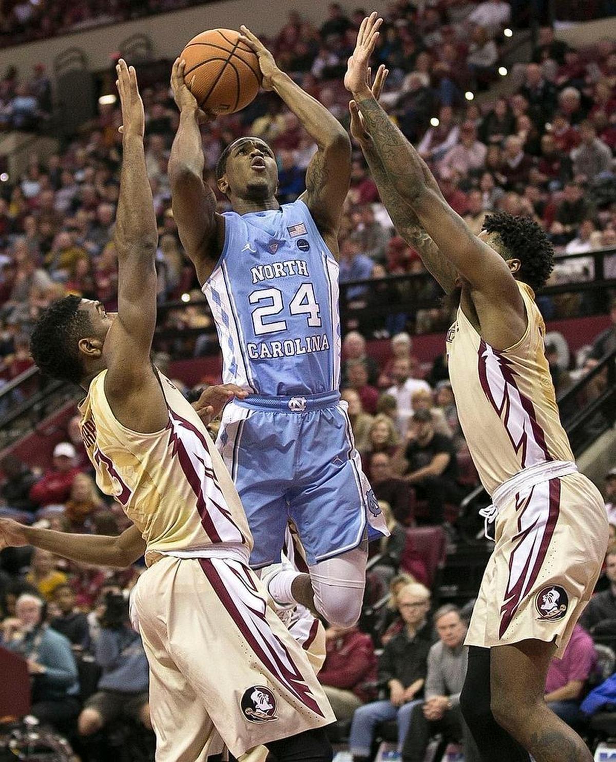 North Carolina’s Kenny Williams (24) between Florida State’s Trent Forest (3) and Phil Cofer (0) during the second half on Wednesday, January 3, 2018 at the Tucker Civic Center in Tallahassee, Fla. Williams scored 18 points.