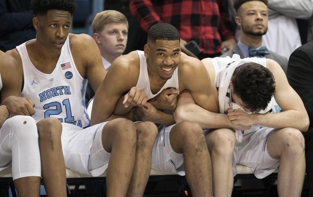 North Carolinas Sterling Manley (21), Garrison Brooks (15) and Andrew Platek (3) lock arms as teammate Cameron Johnson (13) shoots free throws to tie the game at 83.