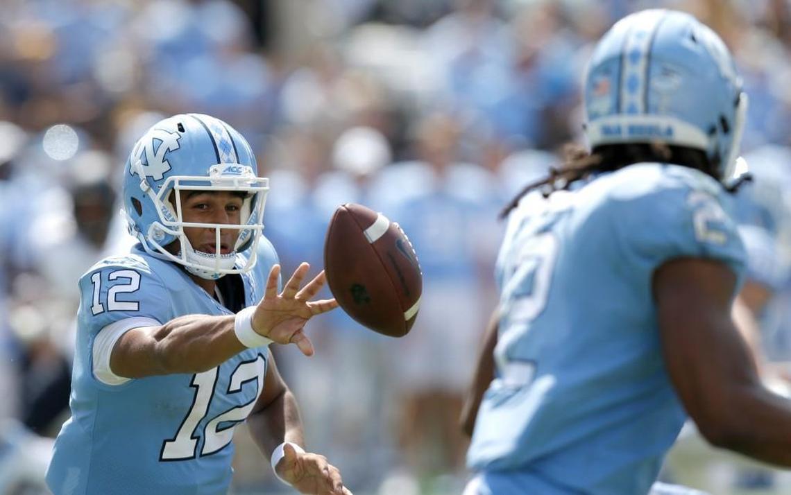 North Carolina quarterback Chazz Surratt, left, tosses the ball to tailback Jordon Brown against California on Sept. 2.