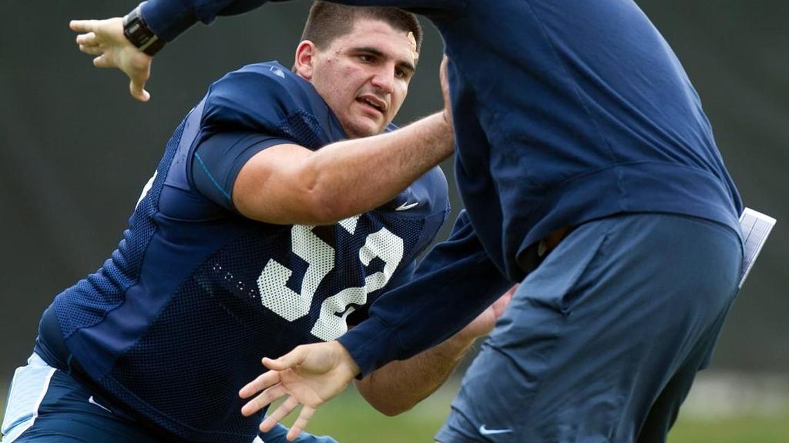 North Carolina offensive lineman Tommy Hatton, left, works on his technique with graduate assistant coach Andrew Mitchell during a Tar Heels’ practice in 2015.