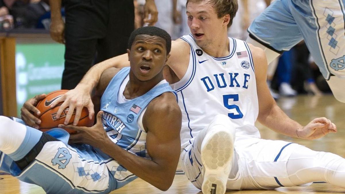 North Carolina’s Kenny Williams (24) and Duke’s Luke Kennard (5) battle for a loose ball during the game at Cameron Indoor Stadium.