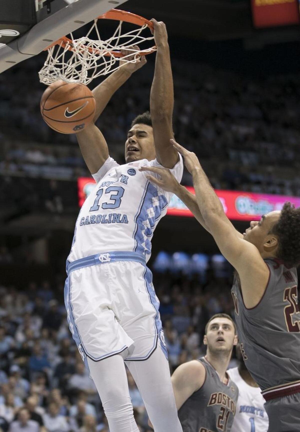 North Carolinas Cameron Johnson (13) dunks over Boston Colleges Jordan Chatman (25) during the first half.