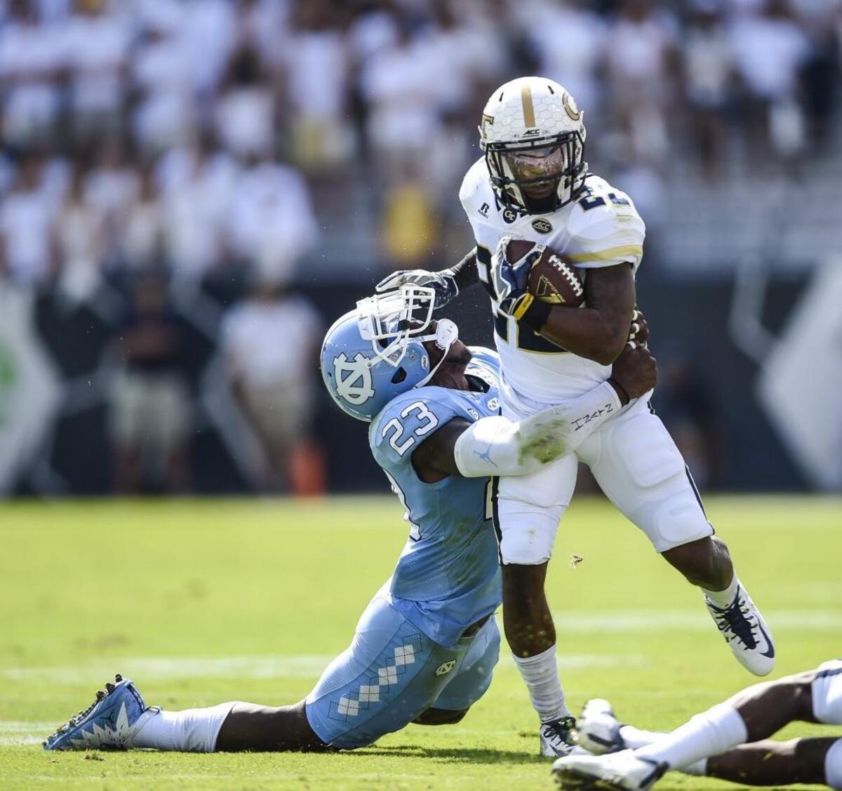 Georgia Tech running back Clinton Lynch (22) runs against North Carolina linebacker Cayson Collins (23) during the first half.
