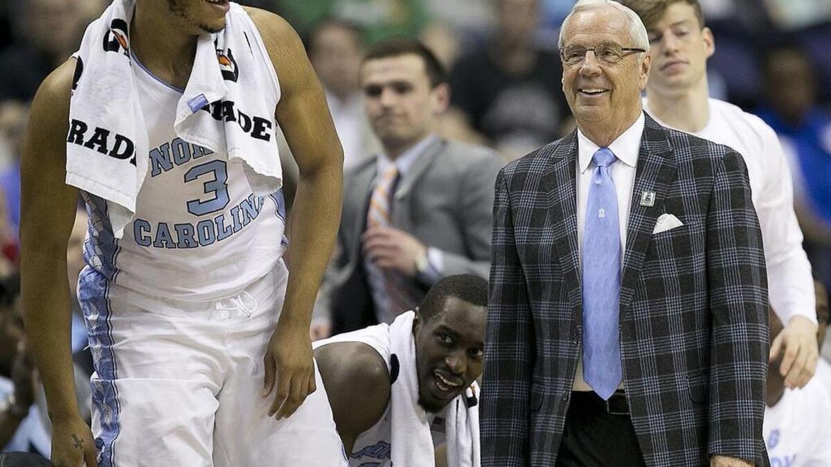 North Carolina coach Roy Williams and Kennedy Meeks smile during the first half.
