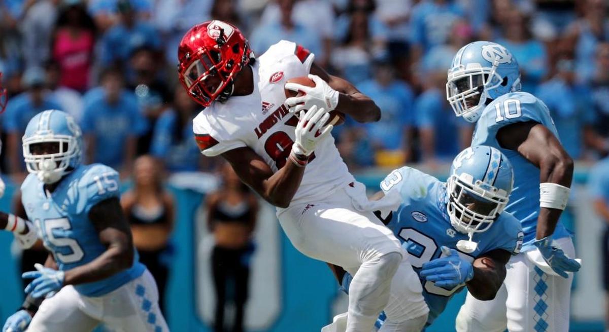 UNC’s Cayson Collins (23) hits Louisville’s Dez Fitzpatrick (87) during the third quarter.