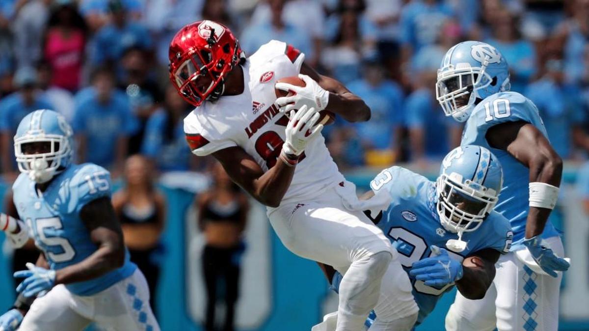 UNC's Cayson Collins (23) hits Louisville's Dez Fitzpatrick (87) during the third quarter.