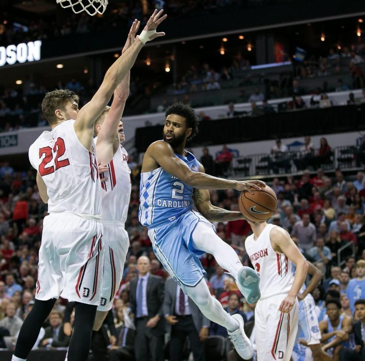 North Carolina’s Joel Berry II (2) drives to the basket against Will Magarity (22) and Peyton Aldridge (23) during the second half on Friday, December 1, 2017 at the Spectrum Center in Charlotte, N.C. Berry led all scores with 27 points in the Tar Heels’ 85-75 victory.