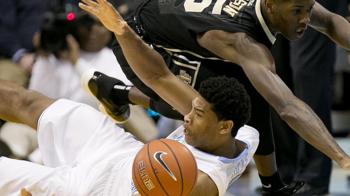 Wake’s Cornelius Hudson, right, and North Carolina’s Isaiah Hicks, left, go after a loose ball during their game Jan. 20. UNC coach Roy Williams didn’t like way team practiced before the team’s sloppy win.