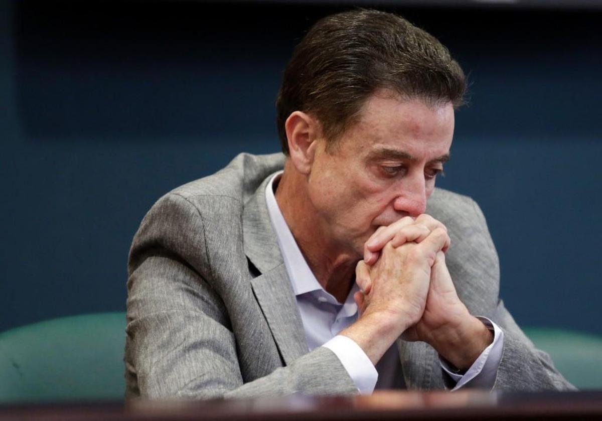 Louisville basketball coach Rick Pitino listens during an NCAA college basketball news conference on Thursday. The NCAA suspended Pitino on Thursday for five ACC games following sex scandal investigation. A former men's basketball staffer is alleged to have hired strippers to entertain players and recruits.