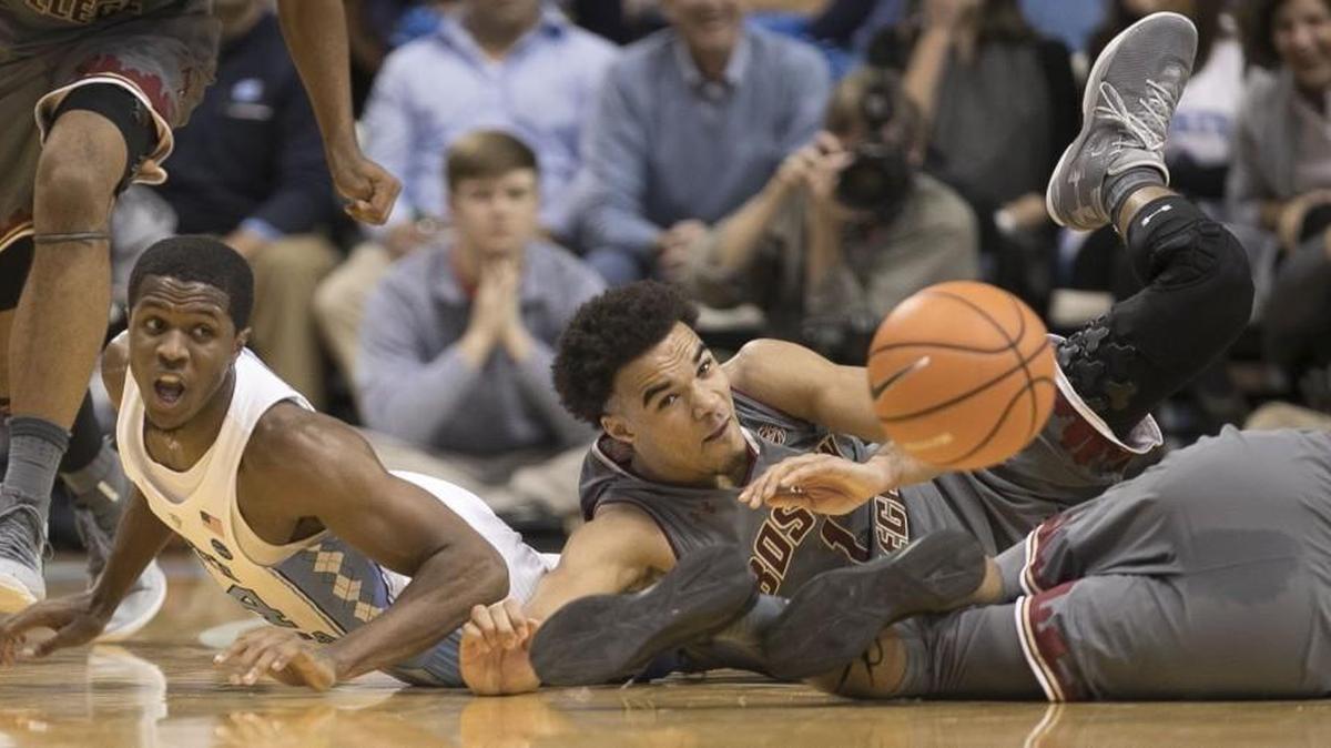 North Carolina’s Kenny Williams (24) and Boston College’s Jerome Robinson (1) hit the court after a loose ball during the first half on January 9, 2018 at the Smith Center in Chapel Hill.