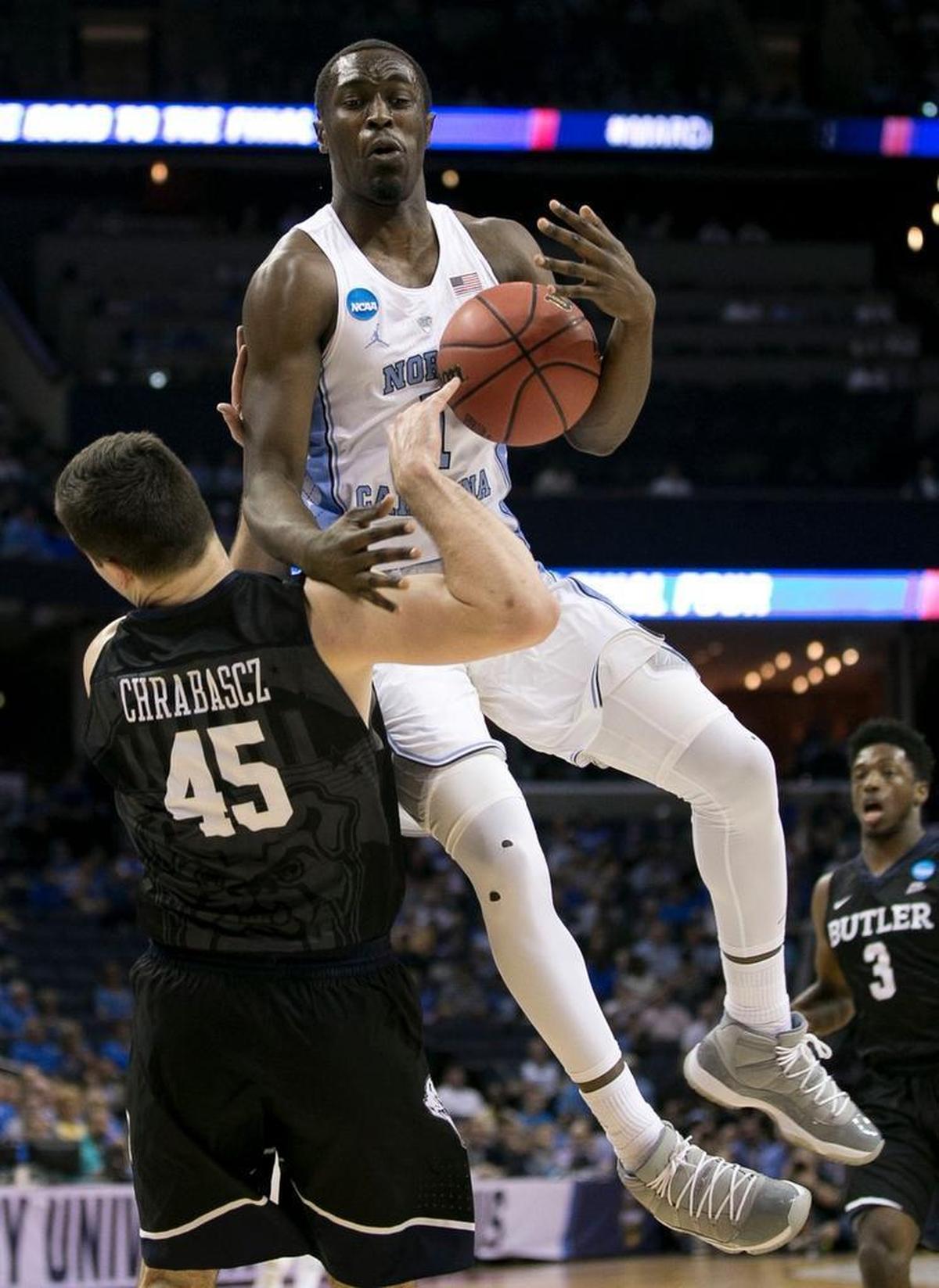 Theo Pinson collides with Butler’s Andrew Chrabascz, left, during the NCAA tournament on March 24.