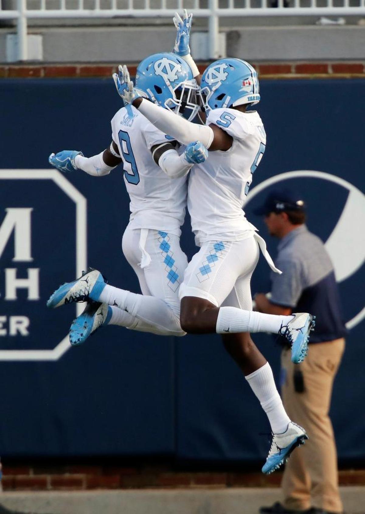 UNC's K.J. Sails (9) and Patrice Rene (5) celebrate a defensive stop during the third quarter.