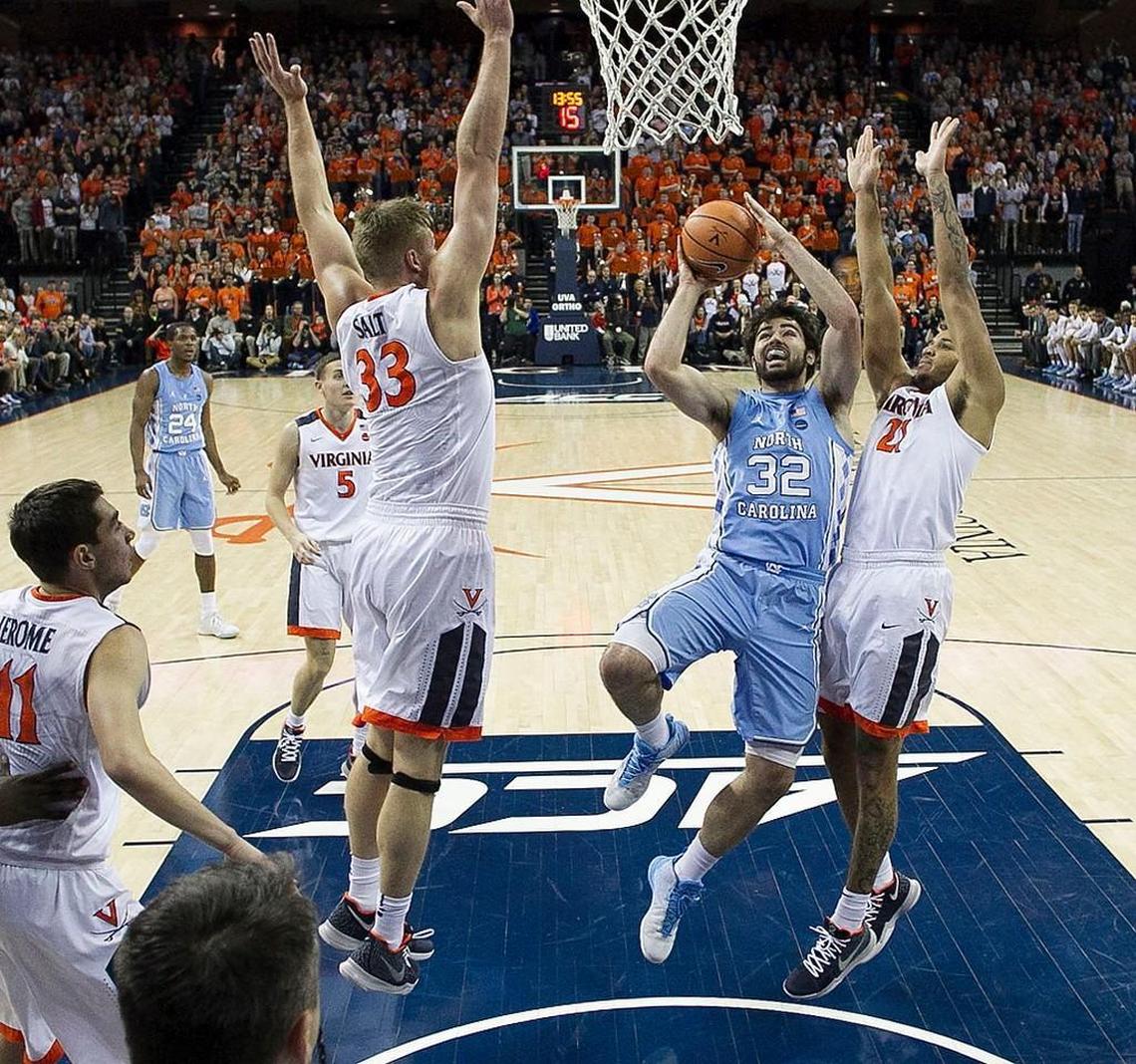 Virginia’s Jack Salt (33) and Isaiah Wilkins (21) defend North Carolina’s Luke Maye (32) during the first half on Saturday, January 6, 2018 at John Paul Jones Arena in Charlottesville, Va. Maye was held to six points in the Tar Heels’ 61-49 loss to Virginia.
