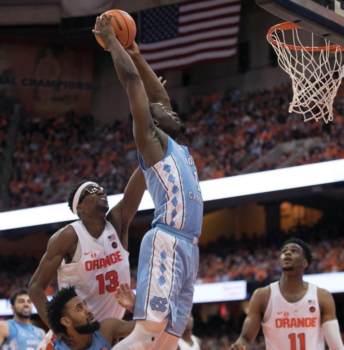 North Carolina’s Theo Pinson (1) gets past Syracuse's Paschal Chukwu (13) for a dunk on February 21, 2018 at the Carrier Dome in Syracuse, NY.