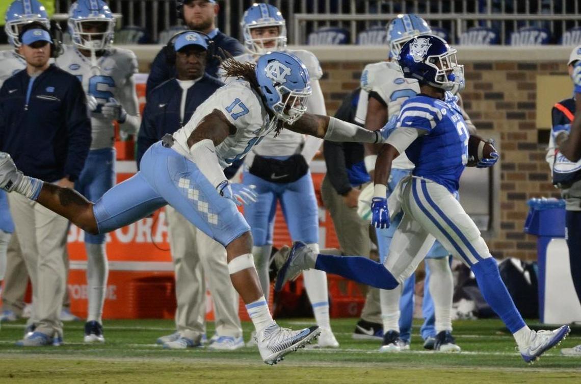 Duke wide receiver T.J. Rahming, right, is shoved out of bounds by North Carolina defensive end Dajaun Drennon in 2016.