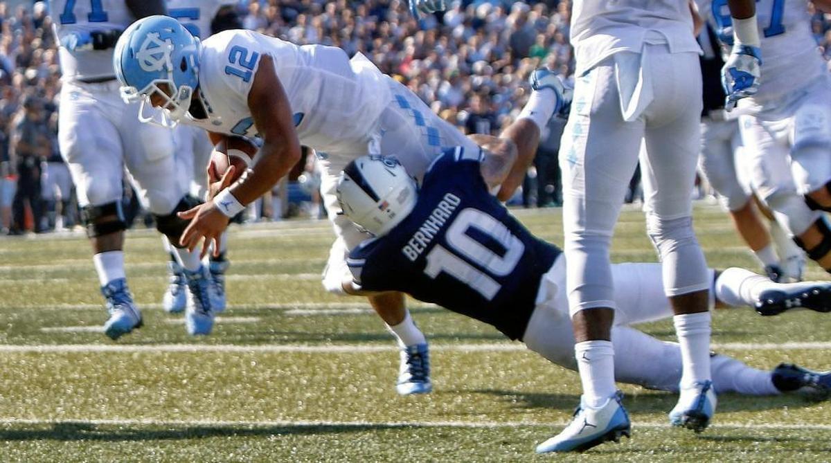 UNC's Chazz Surratt (12) goes over ODU's Andre Bernhard (10) for a TD during the second quarter of a football game between the UNC Tar Heels and the Old Dominion Monarchs played S.B. Ballard Stadium in Norfolk VA on Sept. 16, 2017.