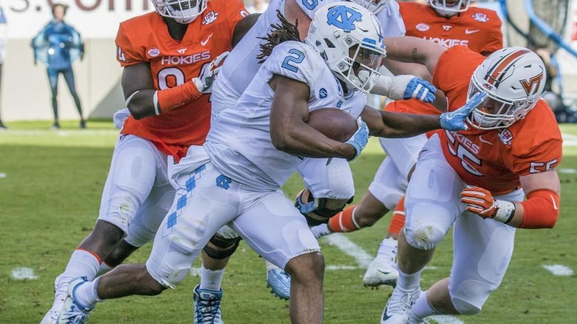 North Carolina running back Jordon Brown (2) gains yardage against Virginia Tech defensive tackle Jarrod Hewitt (55) during the first half of an NCAA college football game, Saturday, Oct. 21, 2017, at Lane Stadium in Blacksburg, Va. (AP Photo/Don Petersen)