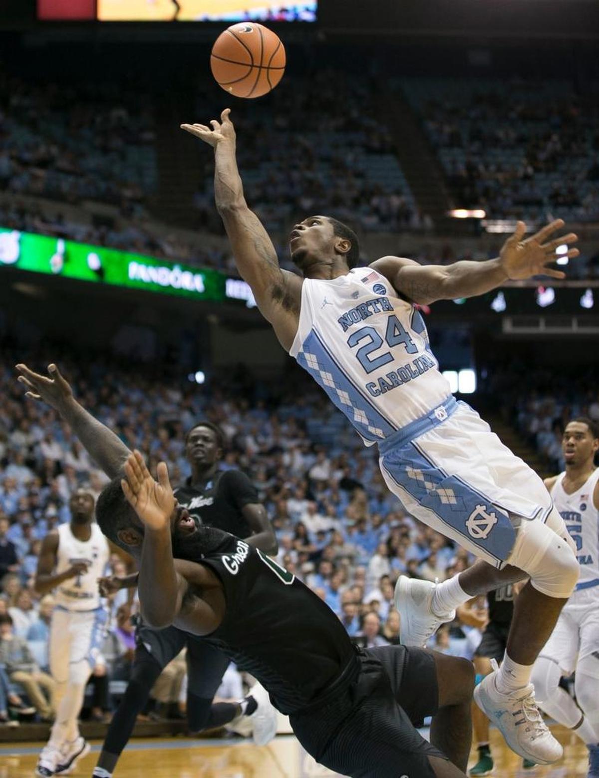 North Carolina’s Kenny Williams (24) puts up a shot over Tulane’s Jordan Cornish (0) during the first half on Sunday, December 3, 2017 at the Smith Center in Chapel Hill, N.C.
