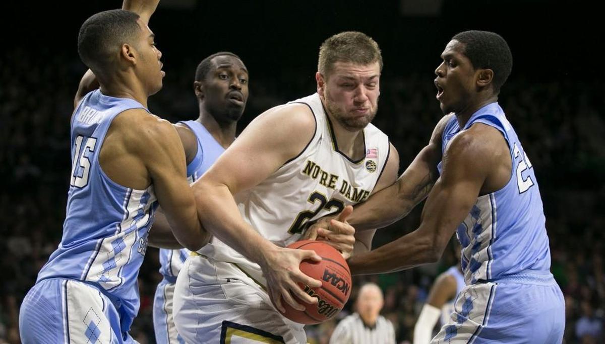 Norte Dames Martinas Geben (23) battles for a rebound with North Carolina's Kenny Williams (24) and Garrison Brooks (15).