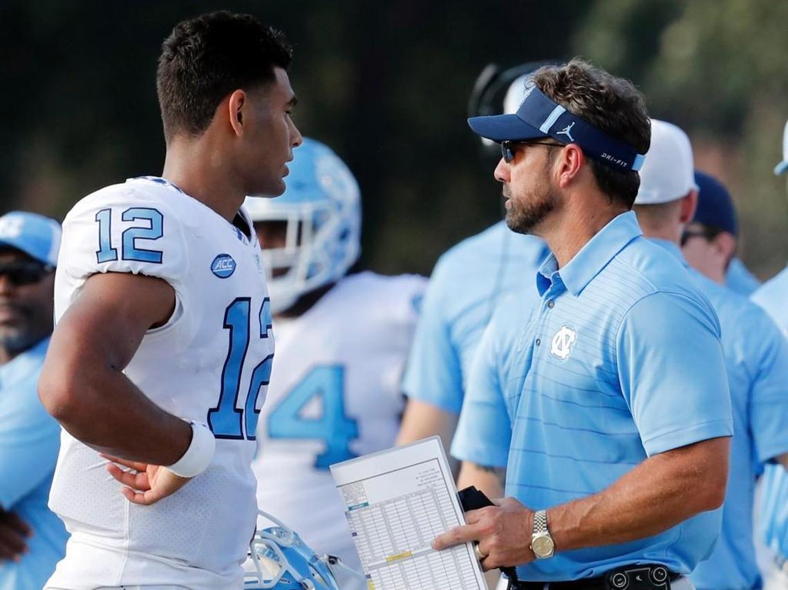 UNC coach Larry Fedora, right, talks to quarterback Chazz Surratt, left, during the Tar Heels game against Old Dominion last weekend.