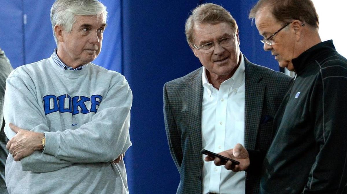 Duke athletic director Kevin White (left) and football coach David Cutcliffe (right) speak with ACC Commisioner John Swofford. Swofford is confident the ACC Network will enhance the league’s revenue stream in 2019.
