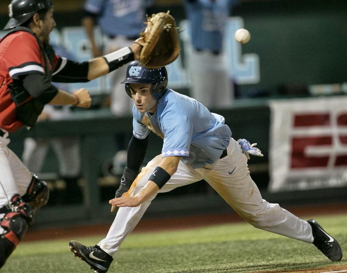 Davidson catcher Jake Sidwell (29) waits on the throw as North Carolina’s Brandon Riley (1) dives into home plate in the ninth inning. Riley was tagged out to help secure the Wildcat’s 2-1 victory and clinch the NCAA regional on Sunday, June 4, 2017 at Boshamer Stadium in Chapel Hill, N.C.