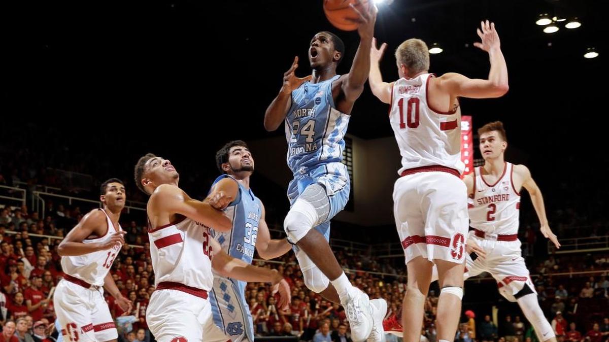 North Carolina guard Kenny Williams (24) drives past Stanford forward Michael Humphrey (10) during the first half.