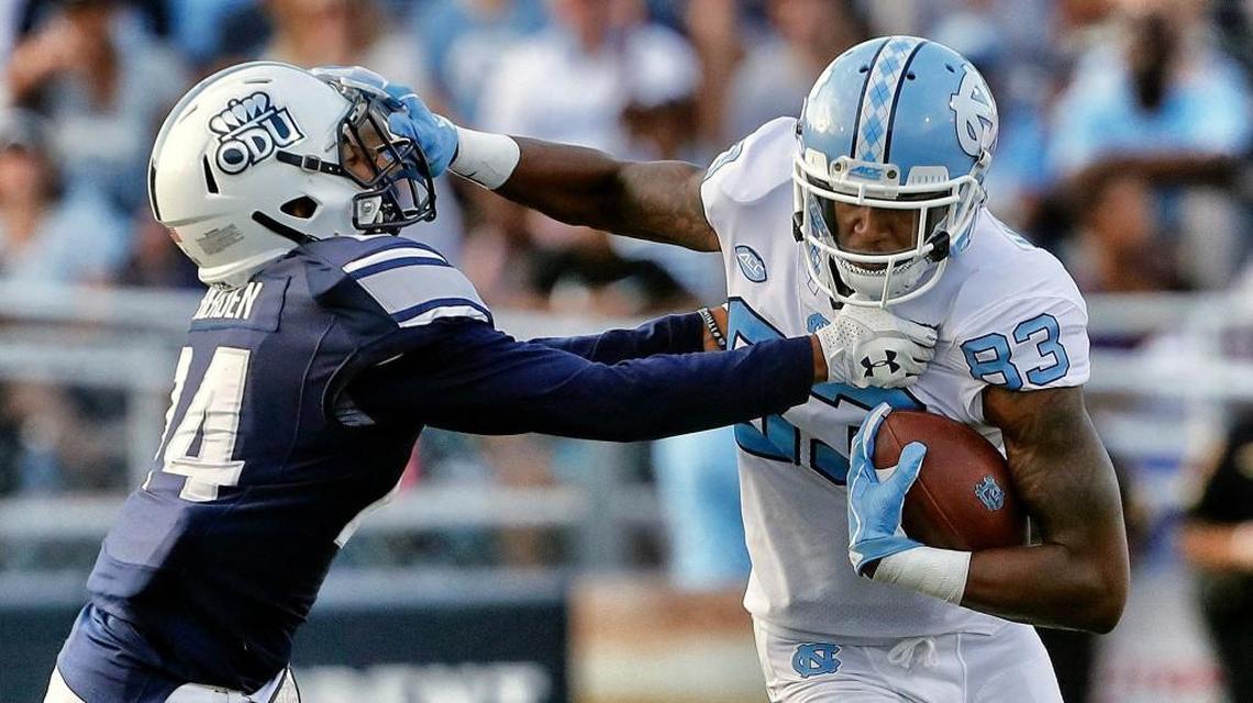 UNC's Juval Mollette (83) stiff-arms ODU's Joe Joe Headen (24) after making a catch during the third quarter.