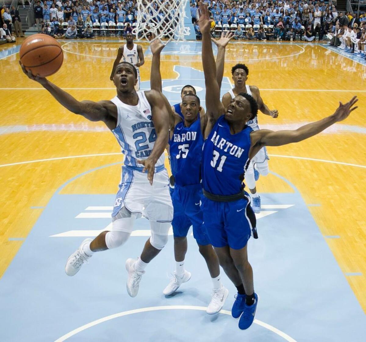 North Carolina’s Kenny Williams (24) drives to the basket against Barton College’s Chris Cook (35) and Jeff Gordon (31) during the first half on October 27, 2017 at the Smith Center in Chapel Hill.