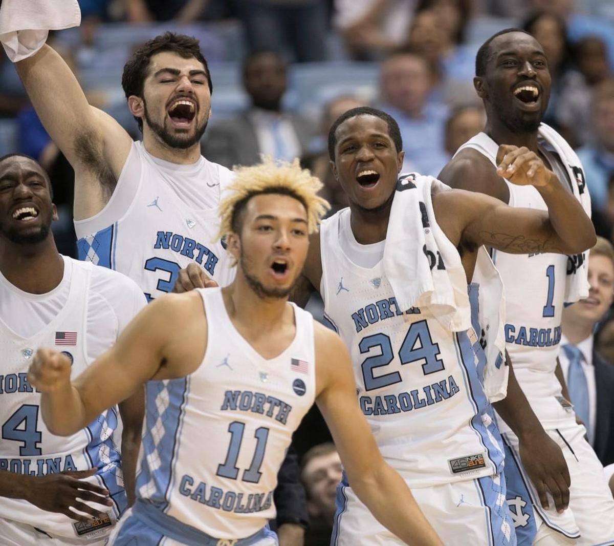 North Carolina’s Brandon Robinson (4), Luke Maye (32), Kenny Williams (24) and Theo Pinson (1) on the bench, react as they watch reserve player Shea Rush’s (11) shot bounce off the rim during the closing minute of play against Tulane on Sunday, December 3, 2017 at the Smith Center in Chapel Hill, N.C. North Carolina rolled to aa97-73 victory over Tulane.