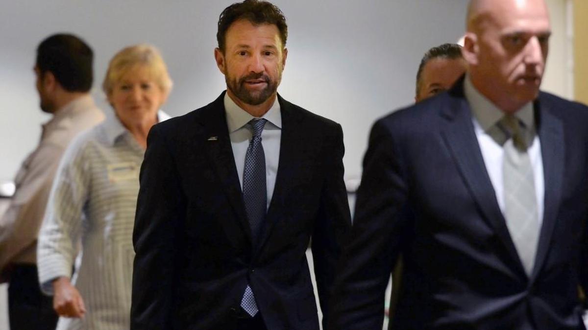 North Carolina football coach Larry Fedora, center, arrives at an NCAA hearing on Wednesday. It has taken more than two years for North Carolina to appear before an NCAA infractions committee panel since initially being charged with five top-level violations amid its long-running academic scandal.