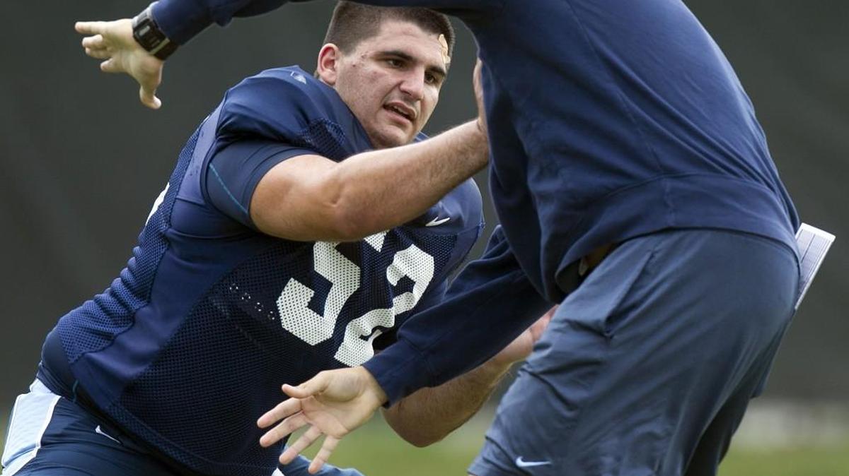 North Carolina offensive lineman Tommy Hatton (52) works on his technique with graduate assistant coach Andrew Mitchell during Tar Heels practice on August 10, 2015 at Navy Field in Chapel Hill.