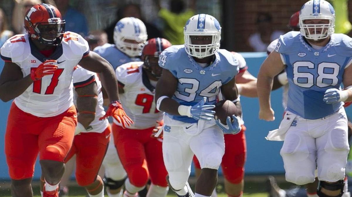 
North Carolina tailback Elijah Hood (34) breaks into the open field for a 39-yard gain in the first quarter against Illinois on Saturday at Kenan Stadium in Chapel Hill.

