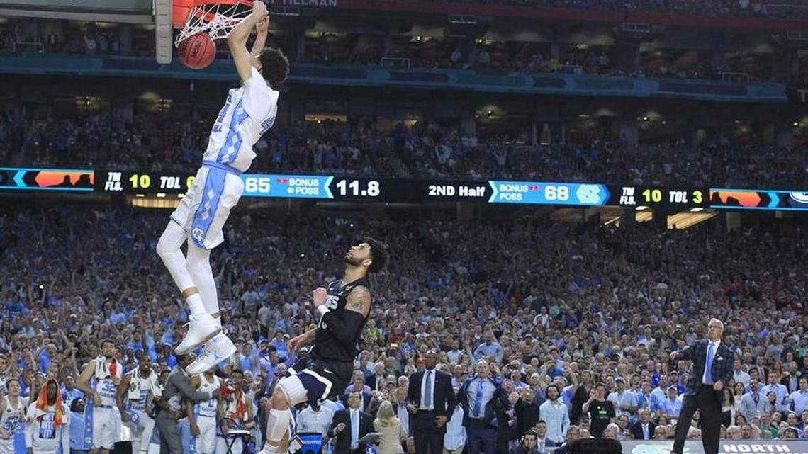 UNC assistant C.B. McGrath is in the background of Justin Jackson’s late dunk on Monday night, just as McGrath has been behind the scenes of much of the Tar Heels’ success the past 14 years.