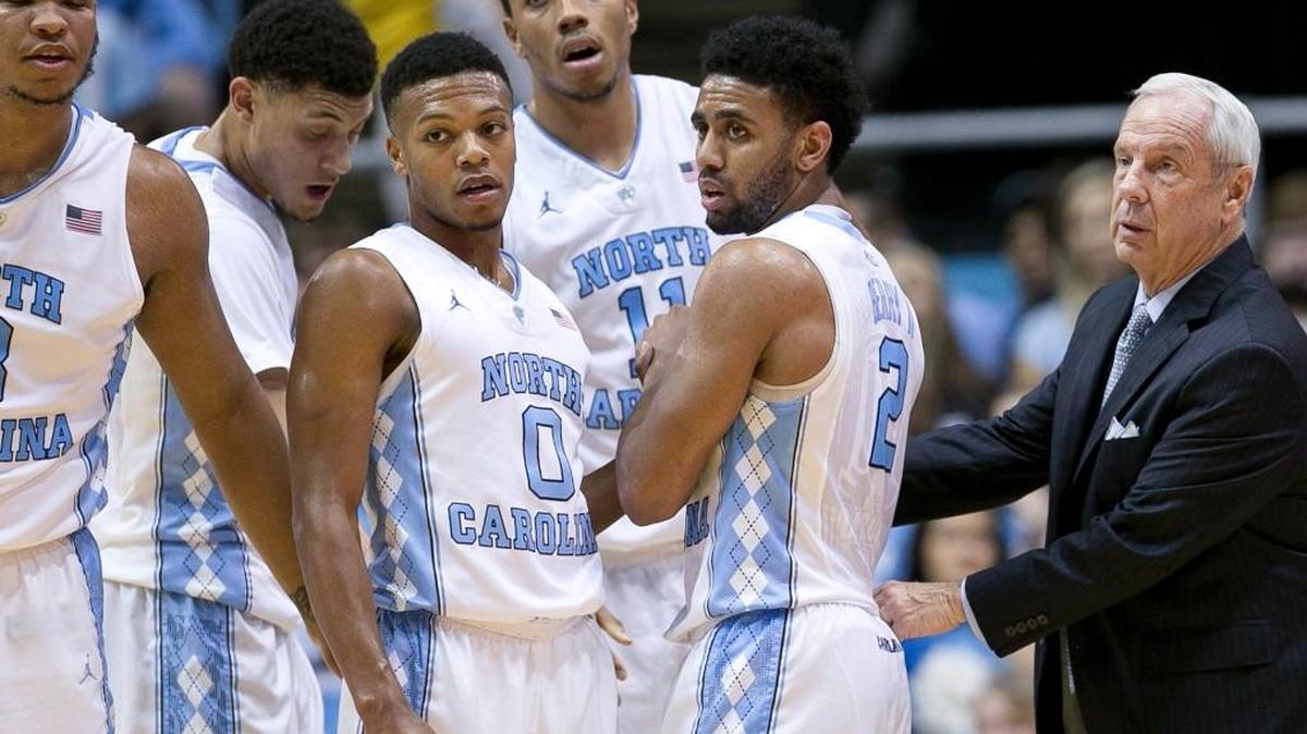 North Carolina coach Roy Williams talks with his players during game against Wofford on Nov. 18. For the first time since the 1996 football season, the UNC football team is ranked higher than the UNC men’s basketball team.