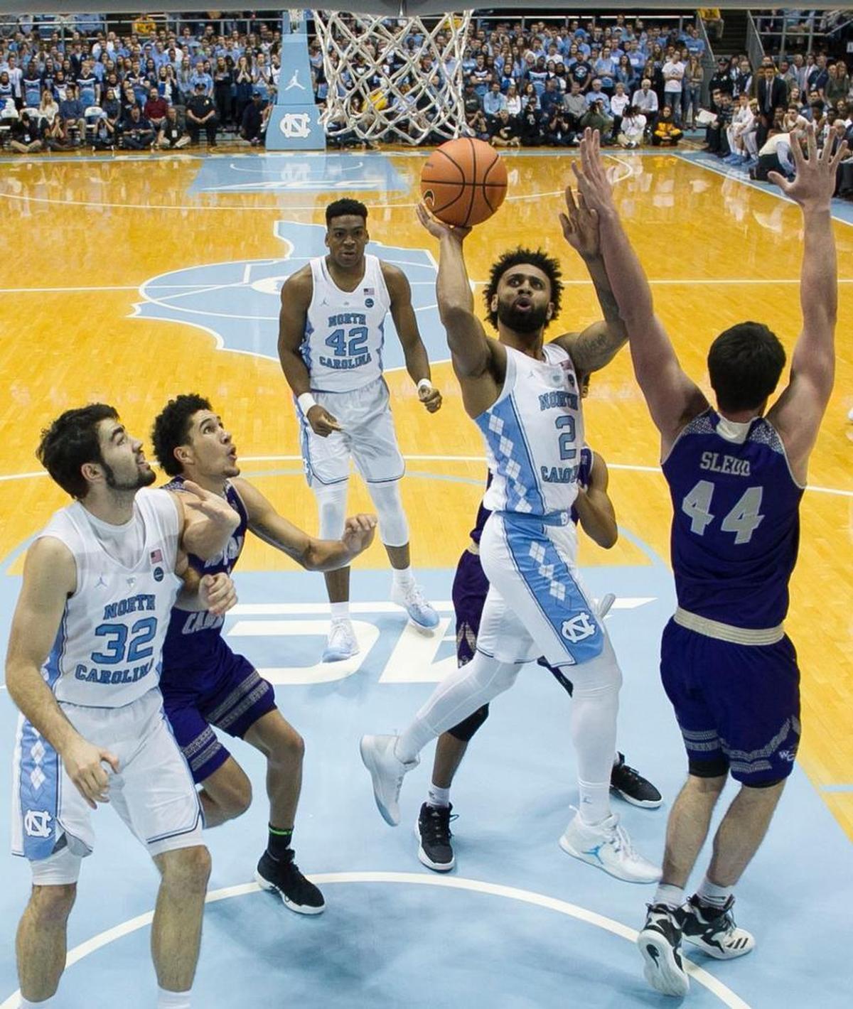 North Carolina’s Joel Berry II (2) drives to the basket against Western Carolina’s Adam Sledd (44) during the first half on Wednesday, December 6, 2017 at the Smith Center in Chapel Hill, N.C.