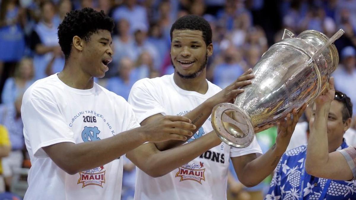 North Carolina's Isaiah Hicks, left and Kennedy Meeks celebrate with the Maui Invitational tournament trophy after North Carolina defeated Wisconsin 71-56 on Wednesday, Nov. 23, 2016, in Lahaina, Hawaii.