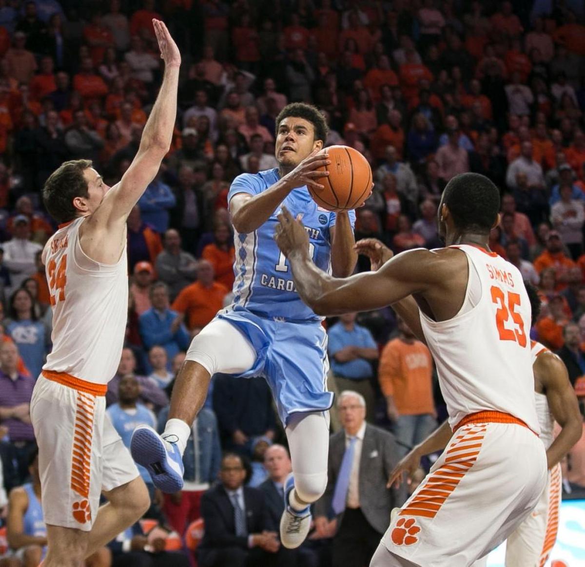 North Carolina’s Cameron Johnson (13) drives to the basket between Clemson’s David Skara (24) and Aamir Simms (25) late in the game on Tuesday, January 30, 2018 at Littlejohn Coliseum in Clemson, S.C. Johnson scored 32 points in the Tar Heels’ 82-78 loss to Clemson.