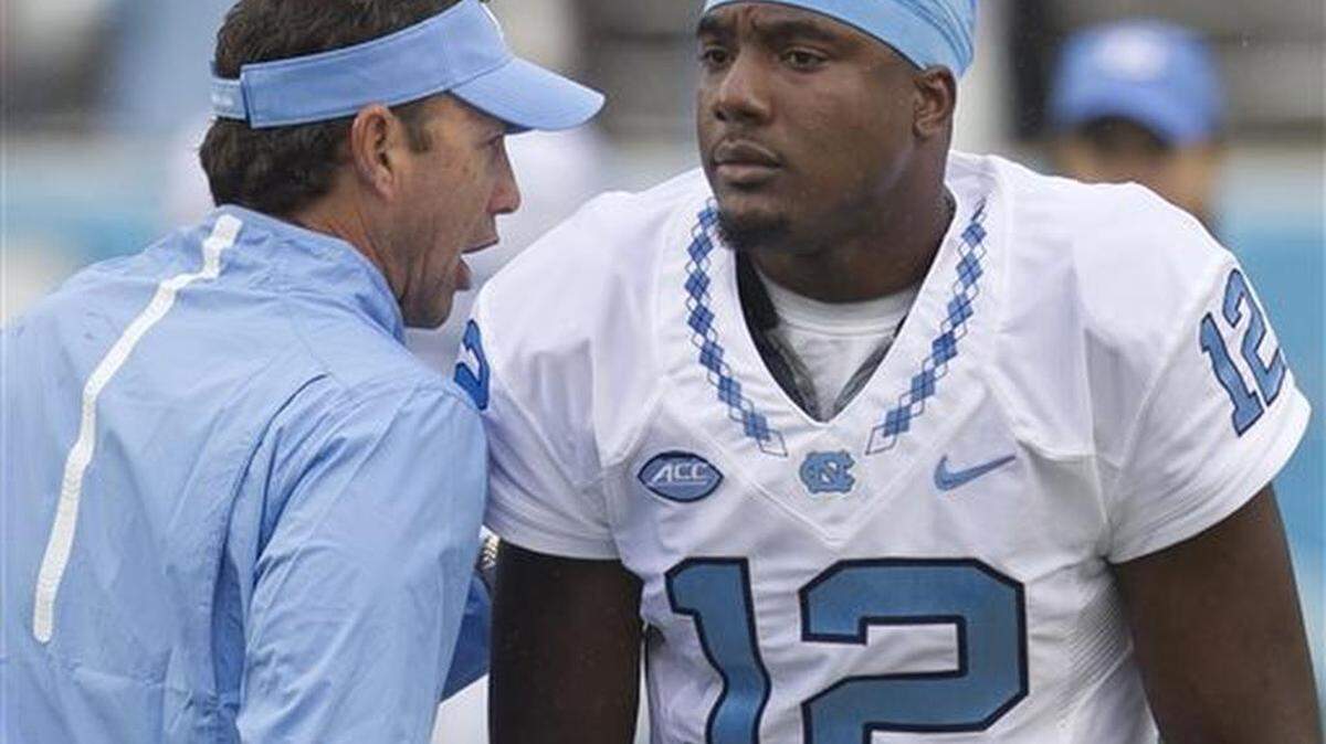 North Carolina coach Larry Fedora talks with quarterback Marquise Williams (12) prior to the Tar Heels’ NCAA college football game against Delaware, Saturday, Sept. 26, 2015 at Kenan Stadium in Chapel Hill, N.C. (Robert Willett/The News & Observer via AP) MANDATORY CREDIT