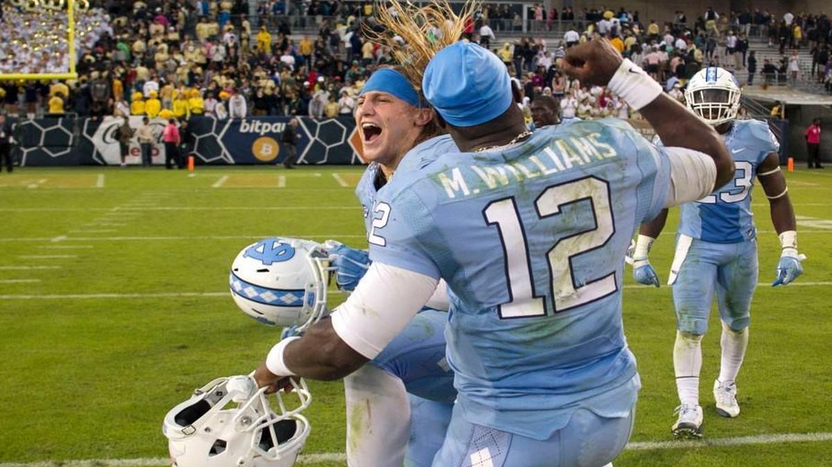
North Carolina’s Jeff Schoettmer and quarterback Marquise Williams celebrate the Tar Heels’ 38-31 victory against Georgia Tech on Saturday, Oct. 3, in Atlanta. The Yellow Jackets opened the season as the favorite to win the ACC Coastal Divison, but an ESPN rating system now considers the Tar Heels the front-runner.
