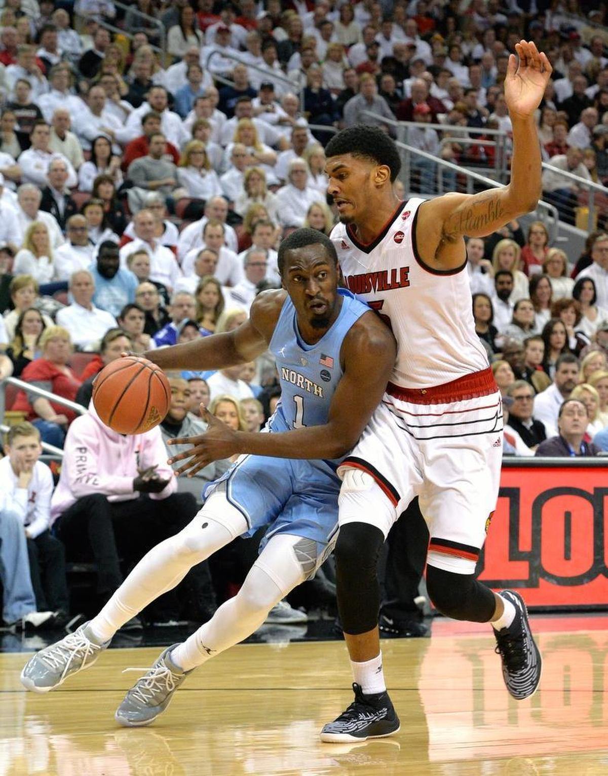 North Carolina forward Theo Pinson (1) attempts to drive past the defense of Louisville forward Malik Williams (5) during the first half, Saturday, Feb. 17, 2018, in Louisville, KY.