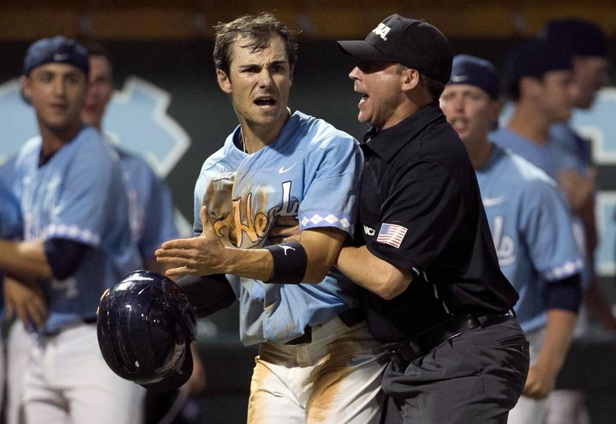 Third base umpire Kevin Sweeney restrains North Carolina’s Brandon Riley (1) as he objects to the call, after he was called out at home in the bottom of the ninth inning by Davidson catcher Jake Sidwell (29) in the NCAA Regional on Sunday, June 4, 2017 at Boshamer Stadium in Chapel Hill, N.C.